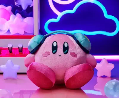 Pink Kirby plush wearing teal headphones sits on a glossy table with pastel star lights and a neon cloud backdrop — Kirby, Super Smash Bros. Melee.