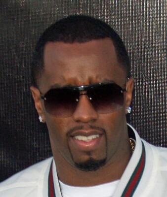 Close-up of Diddy wearing dark sunglasses and a white jacket with a serious expression, related to Don't Breathe.