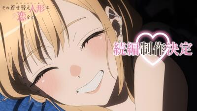 Close-up of a blushing, smiling anime girl from My Dress-Up Darling with closed eyes, blonde hair, earphones, and a pink heart-shaped announcement graphic.