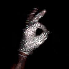 Rhinestone-studded glove forming an OK sign against a black background; image metadata includes the word Drake.