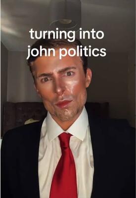 Person in a suit with red tie and sculpted makeup, overlaid text turning into john politics — a John Politics meme portrait.
