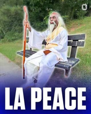 Elderly man in a white robe with long white hair and beard holds a walking staff while sitting on a park bench with a bold LA PEACE caption — La Peace (meme).