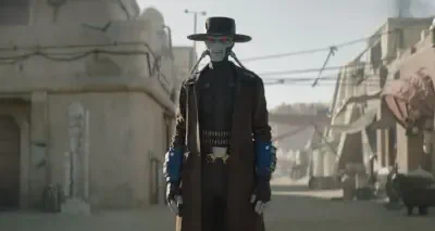 Cad Bane from The Book of Boba Fett stands in a dusty Tatooine street, wearing a wide-brim hat, long duster coat, blue gauntlets, glowing red eyes and twin blaster pistols at his hips.