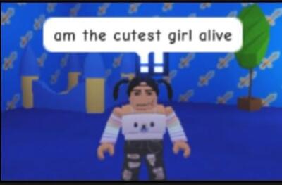 ROBLOX avatar with pigtails wearing a cat-face sweater and ripped jeans stands in a blue room with patterned walls and a potted plant; speech bubble reads am the cutest girl alive.