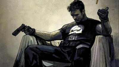 The Punisher sits slumped in an armchair, wearing a black shirt with a white skull, gripping a pistol and a cigarette, shadowed, grime-streaked face and a tense, weary posture.