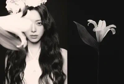 Black-and-white portrait of an unidentified woman with long wavy hair and a floral crown beside a single lily (metadata: ITZY).