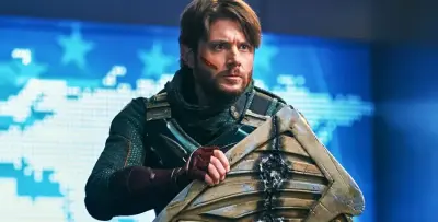Soldier Boy (The Boys) from The Boys in battle-worn armor, gripping a dented shield with a tense stare against a blue backdrop of stars and a digital map.