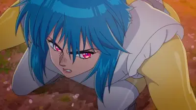 Blue-haired, red-eyed anime figure crouches on the ground, snarling with determination — scene from The Ghost In The Shell (2026).