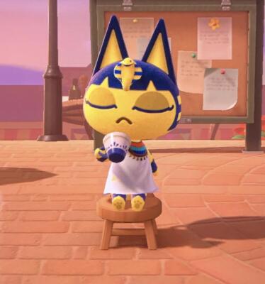 Ankha from Animal Crossing: New Horizons sits on a wooden stool in a plaza, eyes closed, sipping from a mug, wearing her white Egyptian dress and striped headdress with cobra.